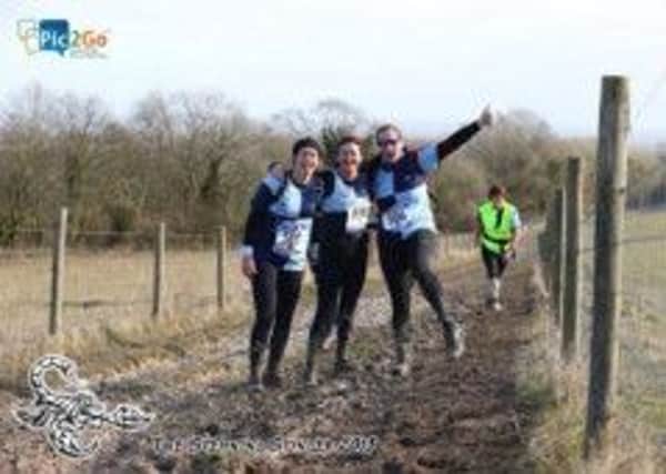 Linda Russell, Hannah Watkins and Marie Carey enjoying muddy section of the Steyning Stinger half marathon with Anne Savidge in the background. Picture courtesy of Sussex Sport Photography Gm364xESyUaWi3hA_tZ1