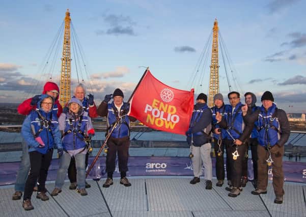 Rotarians raise the End Polio Now flag