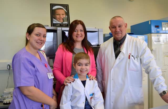 Francesca and her mum Julia Jones with biomedical scientist Malcolm Robinson and healthcare assistant Sam Pursley. Inset, Harvey Buster Baldwin who inspired the Harveys Gang idea