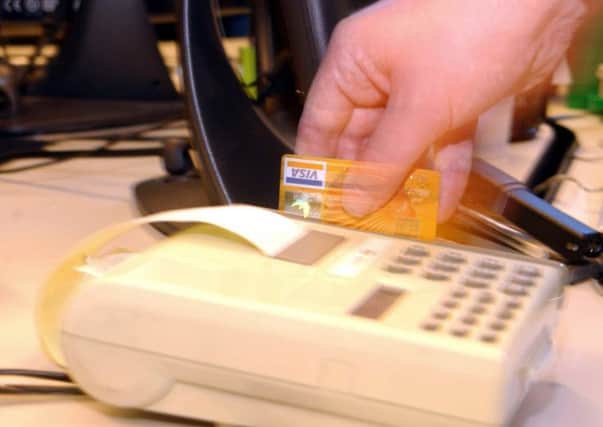 Undated PA file photo of a credit card transaction. Identity theft looks set to increase as credit and debit card companies get to grips with plastic fraud, a report warned Wednesday 25 August 2004.  Market analyst Datamonitor said UK card fraud fell for the first time in nine years during 2003, dropping by 5% to £402.4 million.  The group is predicting that fraud levels will fall even further with the introduction of chip and pin cards.  See PA 0430 Story MONEY Fraud. PA Photo PA*1087883