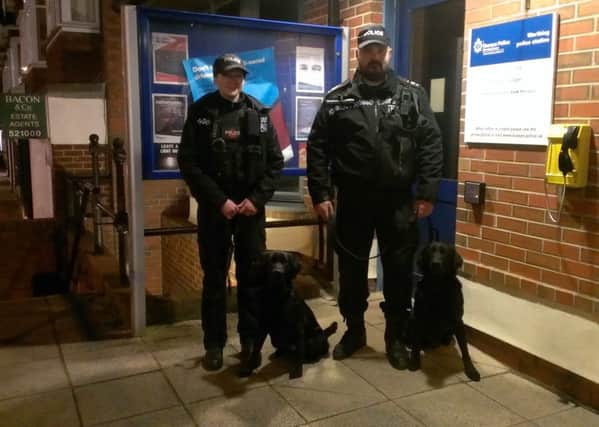 Laura Heathcote and Grant May, operational dog handlers for Surrey Police, with their dogs Mitzie and Sam