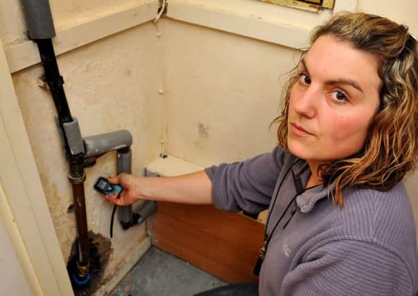 Emma Mitchell has had a problem with damp in her home for the last 10 months, causing damage to the floors and carpets. Emma has reading of 49% humidity and higher in some of her walls. JPCT. Pic Steve Robards SUS-150903-210012001