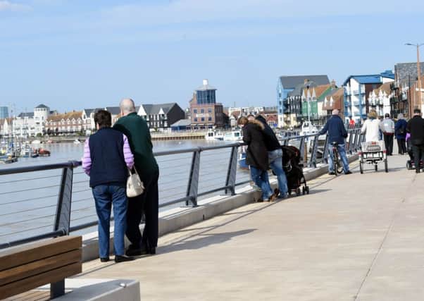 Official Opening of Pier Road. After 18 months of delay Pier Road, part of the riverside development in Littlehampton, is officially opened. Pictured are locals and tourists enjoying the new boulevard. Littlehampton.  

Picture: Liz Pearce. 100315. 
LP1500266 SUS-151003-182153008