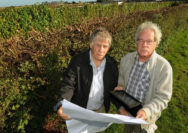 Bill Freeman, left, and UKIP councillor Geoff Patmore study part of the Adur Local Plan at New Monks Farm