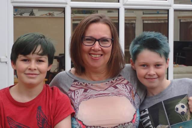 Nathan and Connor Turner who have raised money for the Home-Start Crawley, Horsham & Mid-Sussex (CHAMS) using the game Minecraft. PIcture with mum Paula - photo contributed by CHAMS