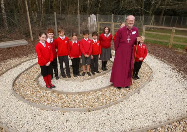 The Bishop of Horsham, the Rt Rev Mark Sowerby with children in the new reflection garden  D15111291a