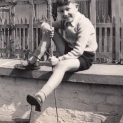 Clive Purser, aged about nine, sitting on the wall of the beer terrace at the front of the new Stanhoe