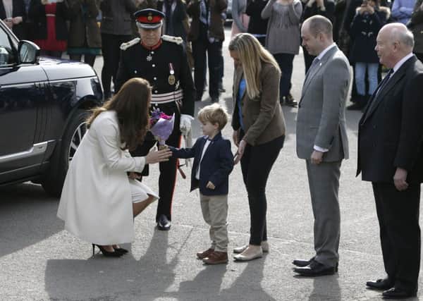 The Duchess of Cambridge meets four-year-old Zac Barker, who plays George in Downton Abbey, while Lord Fellowes (right) looks on, as she arrives for a visit to the world famous Ealing Studios in west London, where she met the cast and crew of the popular drama. PRESS ASSOCIATION Photo. Picture date: Thursday March 12, 2015. See PA story ROYAL Kate. Photo credit should read: Steve Parsons/PA Wire SUS-150316-165147001