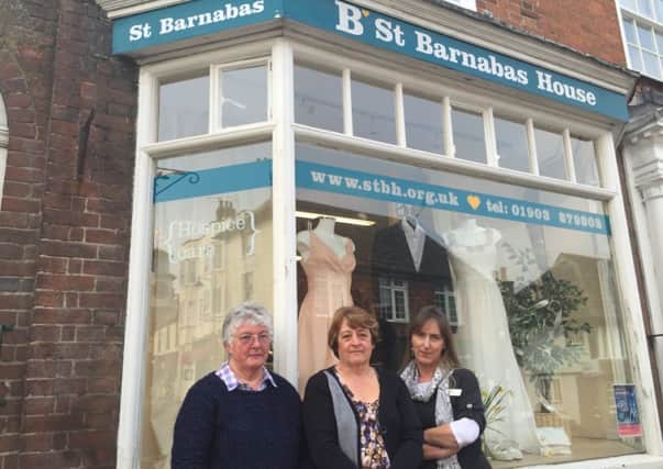 Jenny Marsh, Christine Berrill and Lisa Wigg outside St Barnabas House charity shop after the break-in