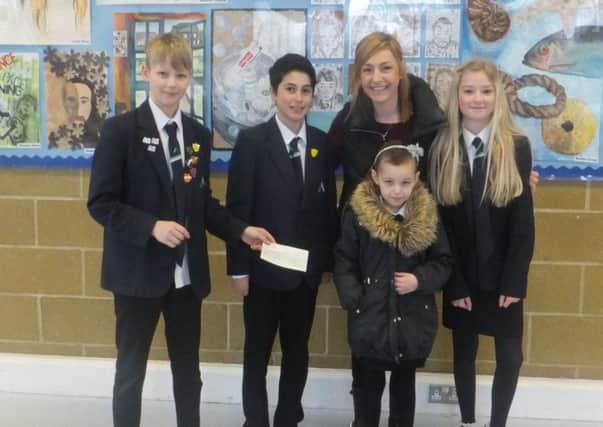 Year-seven students meet Samantha Riley and her daughter Issey, who they helped raise hundreds of pounds for in a fun run, last week SUS-150324-170325001