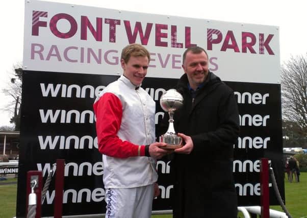 Craig Roberts presents Fontwell's champion jockey trophy for 2014 to Tom Cannon  Picture by Steve Bone