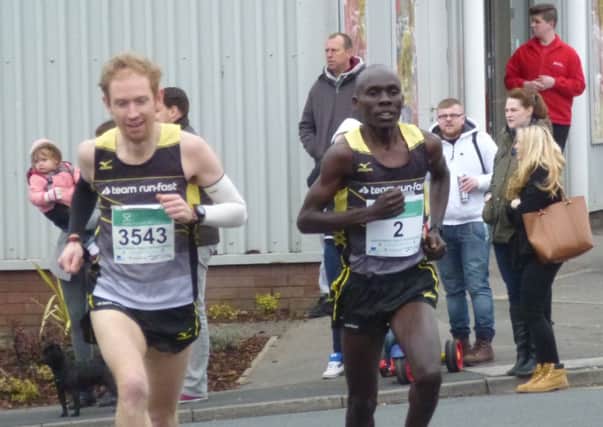 Hastings Half Marathon winner Sammy Nyokaye (right) and runner-up Tom Payn (left) make the early running. Picture by Simon Newstead