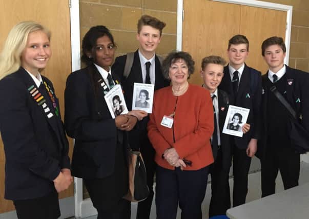 Year-nine students, Charlotte Stacey, left, Dilaxiha Rajendran, Matthew Davies, Ross Moore, Bradley Bell and Thomas Carver right, with Holocaust survivor, Dorit Oliver-Wolff, centre.
