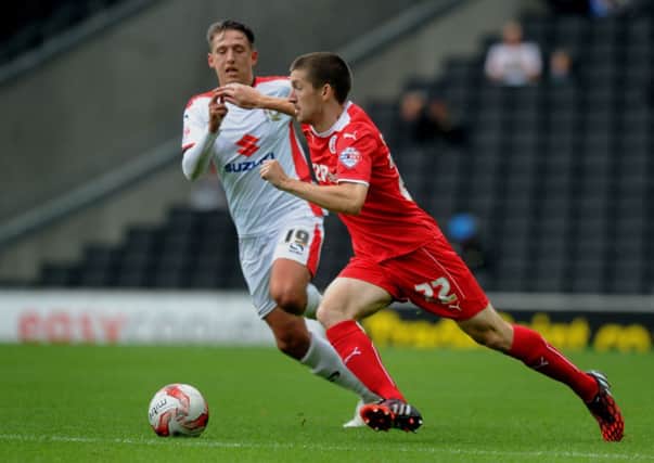 Crawley's Dean Emmett O'Connor battles  against MK Dons' Tom Hitchcock  (Pic by Jon Rigby) PPP-140830-215903004