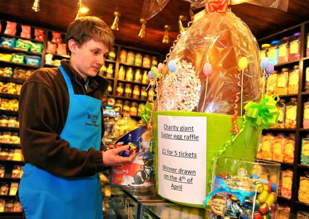 Jamie Hadaway at Mr Simms Sweet Shop, Horsham witha giant Easter egg. Pic Steve Robards SUS-150325-165659001
