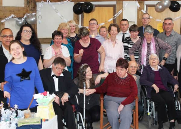 Southdown staff with residents at Brook Court and their families celebrating the services tenth anniversary (photo submitted). SUS-150326-134227001