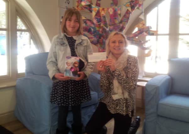 Ruby Tedeschi presents a cheque at Chestnut Tree House