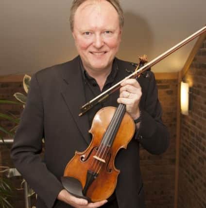 Artistic director Andrew Bernardi with a 1696 Stradivarius