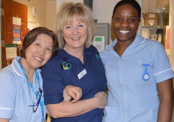 Cathy (centre) with colleagues from Buckland ward at East Surrey Hospital SUS-150330-105040001