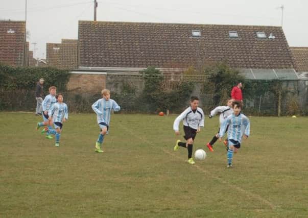 Avisford under-11s (black and white) in charge against Worthing