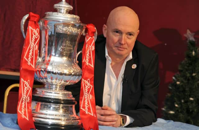Dave Walters sits alongside the FA Cup during Hastings United's amazing run to the world famous competition in the 2012/13 season