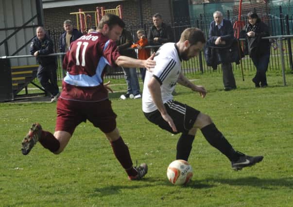 Bexhill United wide player Allan McMinigal tries to take on Little Common midfielder Jared Lusted. Picture by Simon Newstead (SUS-150604-181044002)