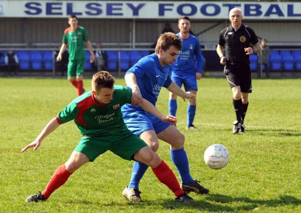 Lloyd Rowlatt of Pagham and  Toby Lempriere of Selsey vie for possession / Picture by Louise Adams LA1500064-3