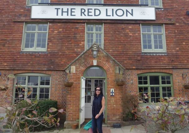 Cathy Price has spent the past four years visiting every Red Lion Pub in the British Isles, plus 10 others abroad. Pictured at the Red Lion in Ashington - picture submitted