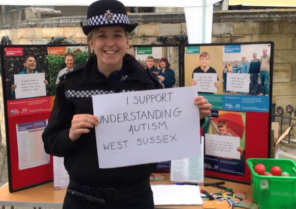 Horsham PCSO Charlene Parsons pledges her support to the West Sussex autism awareness campaign. She was attending one of several events held across the county. Picture contributed by West Sussex County Council