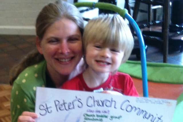 Georgina Carter and her son with the St Peter's RC Church presentation boards