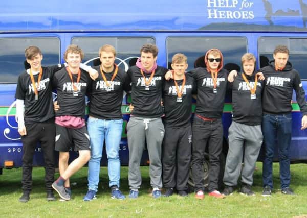 College of Richard Collyer pupils take part in the Warrior Run for Help the Heroes. The students are pictured with the Buttle Bus Tours bus, which gets hired out for Help the Heroes events - picture submitted XMyXVTPVyGuRGI01scji