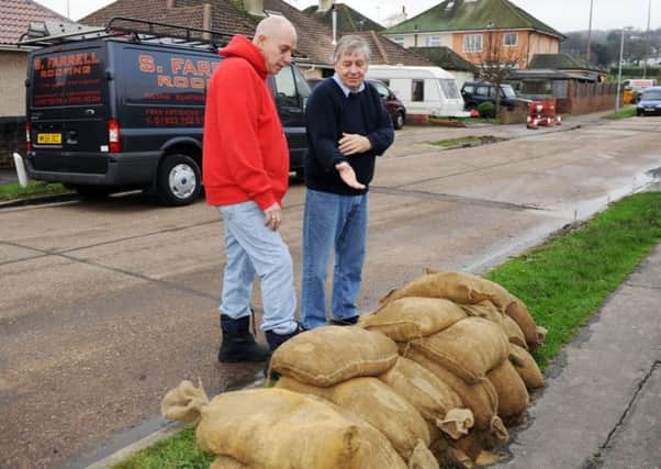Bill Freeman, right, from Adur Floodwatch Group, and Sompting resident Bob Simpson discuss sandbags