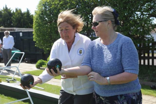 Witterings Bowls Club member Jan Derkatsch shows open day visitor Pip Batten bowling techniques / Picture by Louise Adams