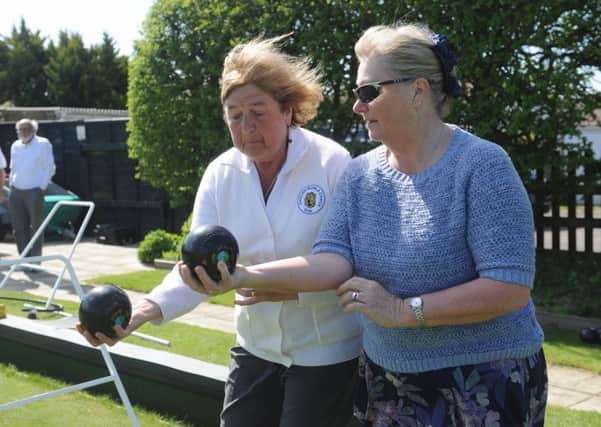 Witterings Bowls Club member Jan Derkatsch shows open day visitor Pip Batten bowling techniques / Picture by Louise Adams