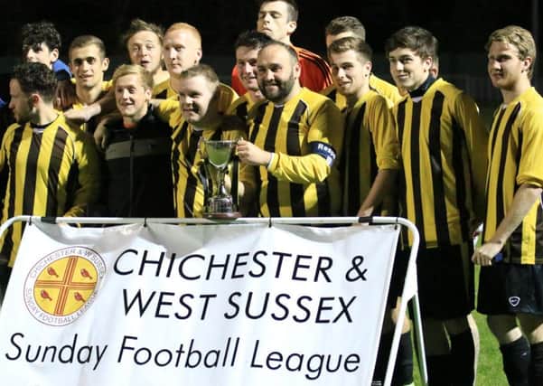 Hunston Community Club celebrate their trophy win