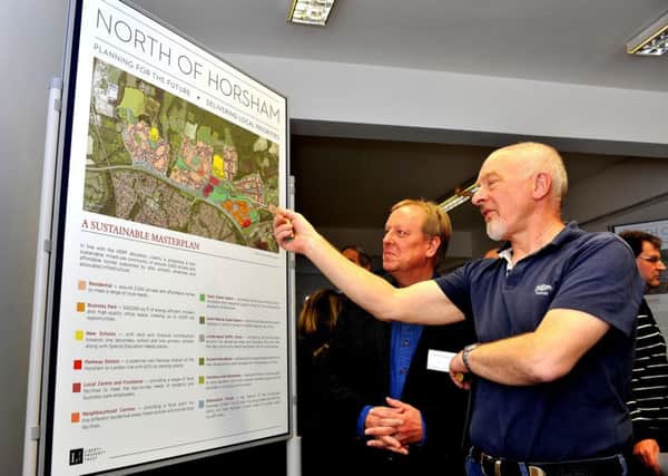 Developer Liberty are bringing approximately 2,500 homes to North Horsham held a housing exhibition in the town centre. Brian Sutherland, BDB Design, Masterplanning, with a member of the public. Pic Steve Robards SUS-150418-204819001
