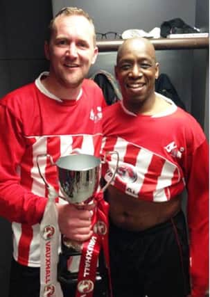 Paul Hodder, of Wick, holding his Wembley trophy with retired football icon Ian Wright SUS-150427-160516001