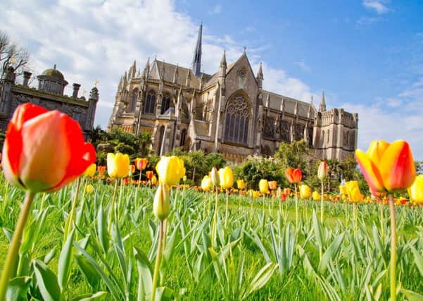 Tulips in Arundel Castle with the town's cathedral in the background SUS-150428-174609001