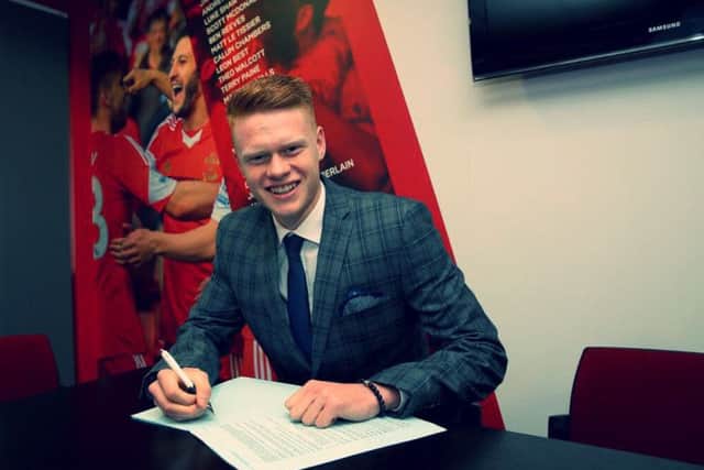 Will Wood signs his professional contract. Picture by Matt Watson/Southampton FC
