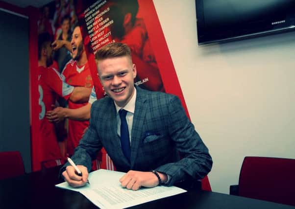 Will Wood signs his professional contract. Picture by Matt Watson/Southampton FC