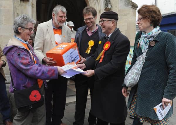 Jan and Bob Birtwell of 38 Degrees handing over the petition to local candidates, Andrew Smith (LibDem) Mark Farwell (Lab) and representing the Greens Sarah Sharp.LA1500110-1 SUS-150426-210246008