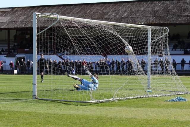 Sam Adams converts a penalty for Hastings United's first team to seal a 2-1 win at home to Faversham Town last weekend. Picture courtesy Scott White
