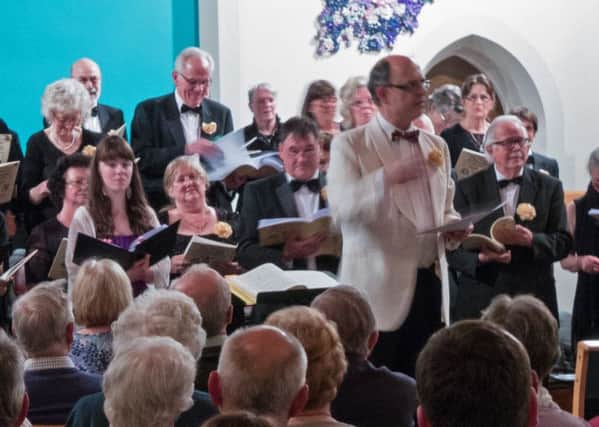 Musical director Andrew Sutton with Mid Sussex Choir. Picture by David J Waterhouse