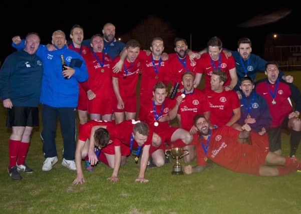 Bosham celebrate their cup win / Picture by Tommy McMillan