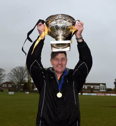 Golds boss Mark Bennett lifts the County League title