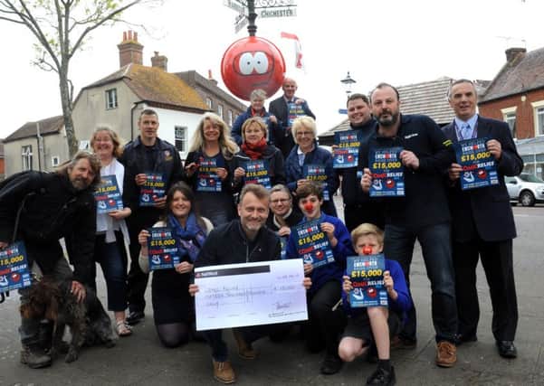 Hugh Dennis received the cheque for £15,000 on behalf of Comic Relief, from the money raised by the Red Nose Day in Emsworth.Picture by Kate Shemilt