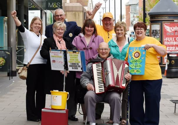 Fundraising accordion player retires. Accordian player, George Spewing, retires at the age of 86. Pictured  with charity volunteers from Chestnut Tree House and his sisters, Paula White and Cynthia Maynard. 
Worthing. 

Picture : Liz Pearce. 010515
LP1501438 SUS-150105-190501008