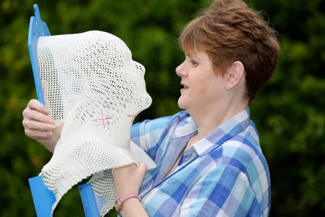 Claustrophobic Kate pictured with her mesh mask she had to wear during treatment