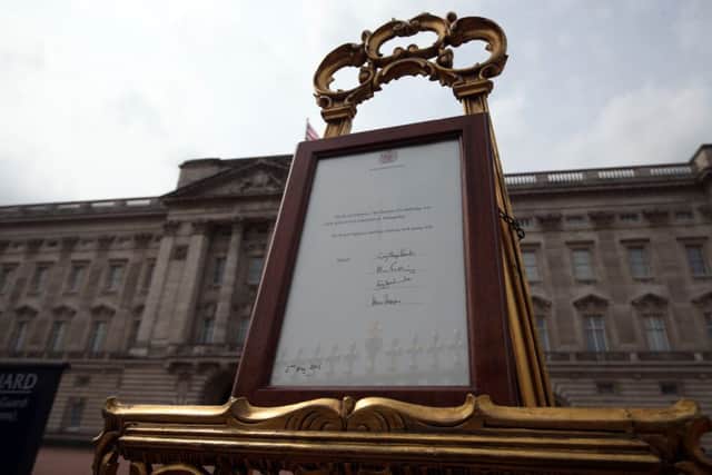 An easel is placed in the Forecourt of Buckingham Palace in London to announce the birth of a baby girl. Steve Parsons/PA Wire EMN-150205-131624001