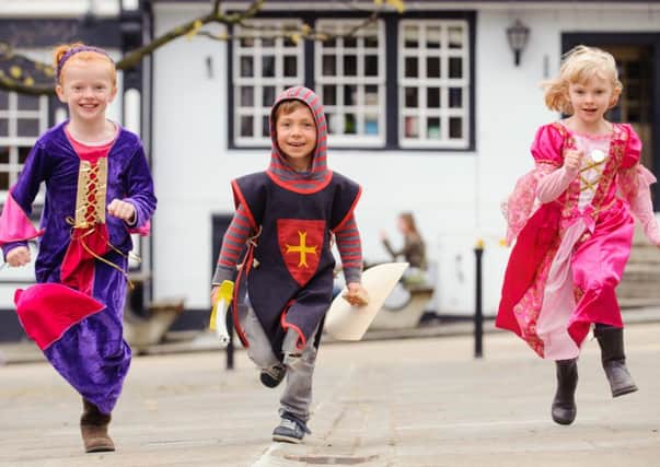 (l-r) Rosie Waterhouse (8), Ewan Willis (4) and Ella Waterhouse (6).   Medieval Midhurst festival, Market Square, Midhurst.  Picture by Allan Hutchings
